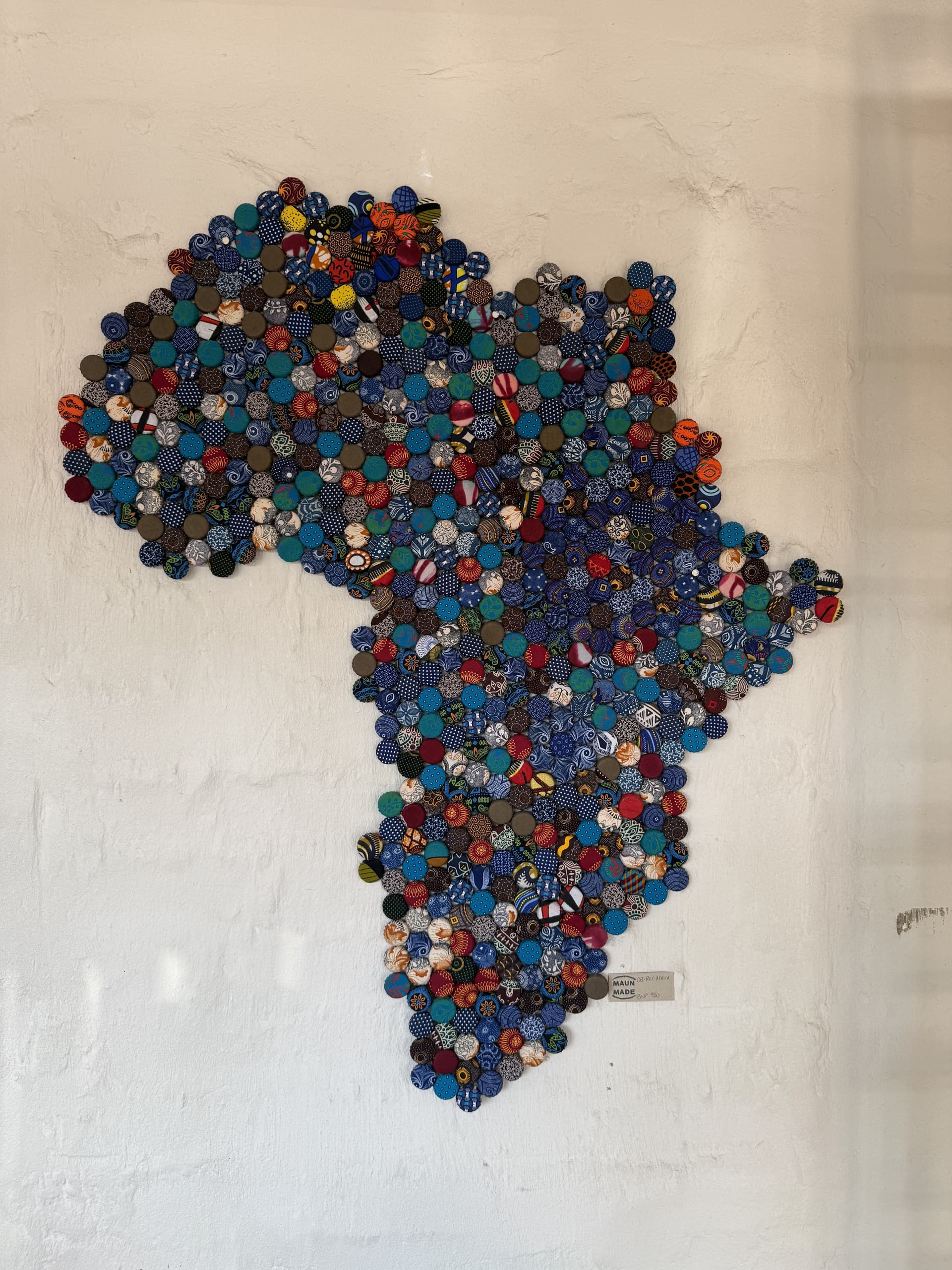 Handcrafted button-art map of Africa displayed on a wall inside the lounge at Samonyana Private Island
