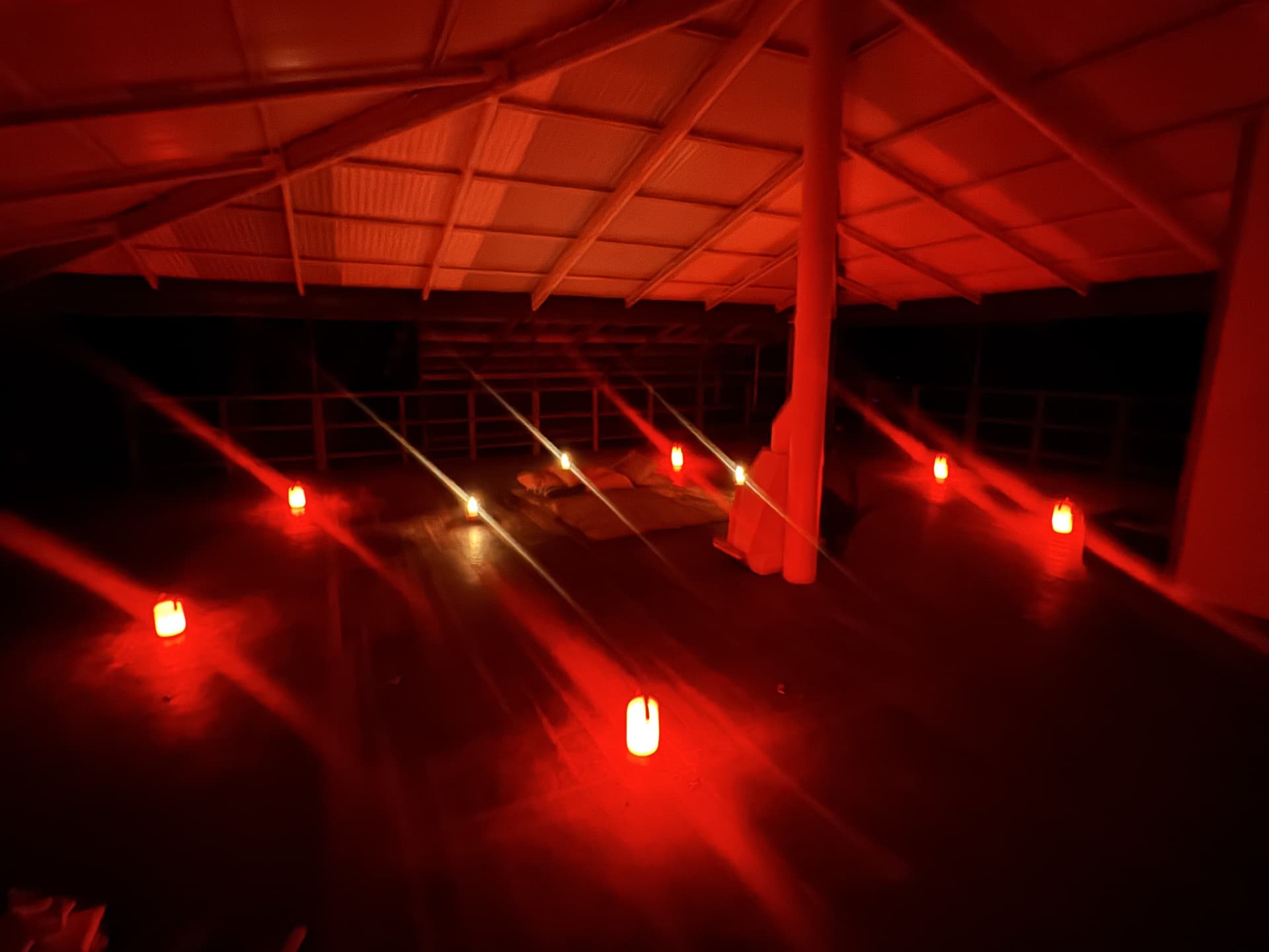 Covered deck at Samonyana strung with rows of glowing lanterns at night.