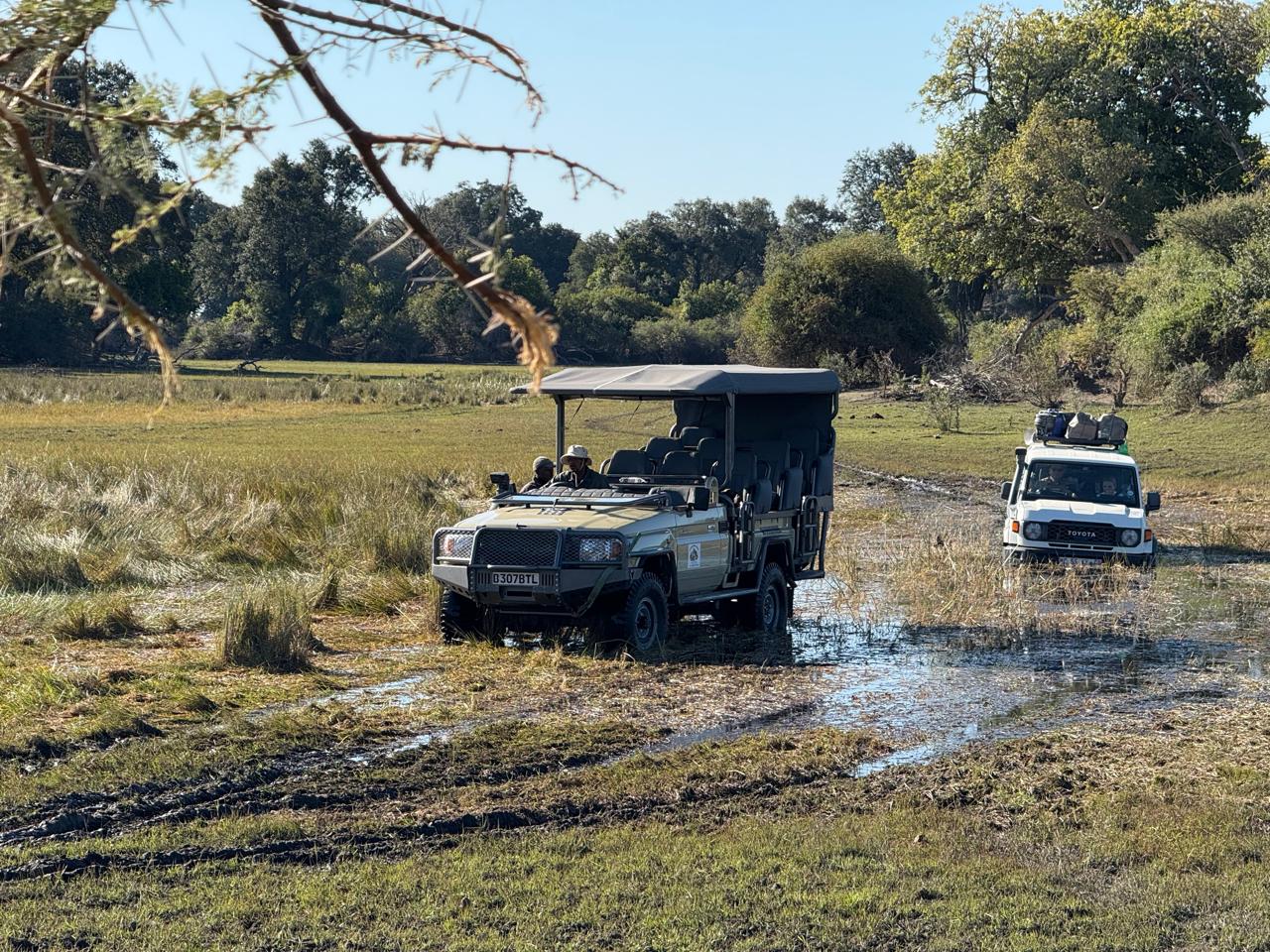 4x4 vehicles crossing a water channel on the self-drive route to Samonyana