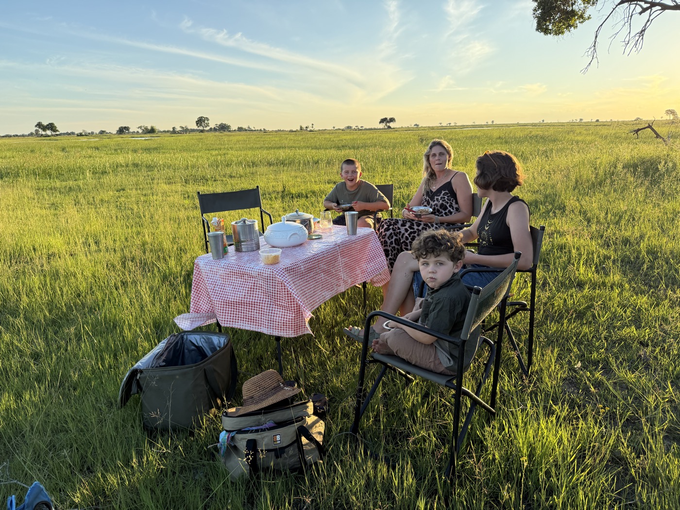 Family dining outdoors on the Okavango Delta floodplain at Samonyana Private Island
